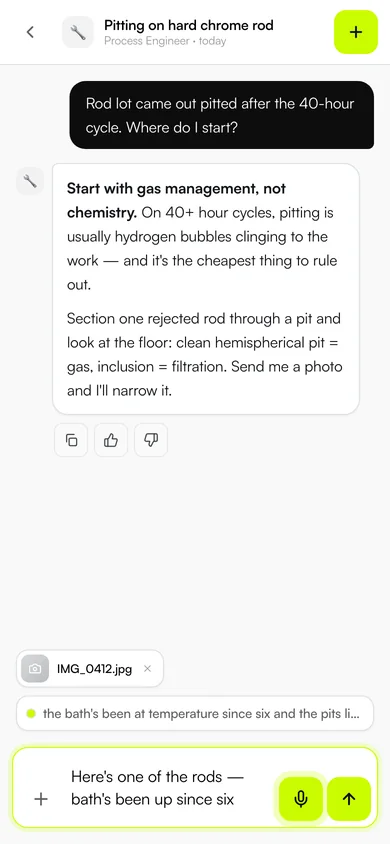 The phone app mid-dictation: a photo of a pitted chrome rod attached, the spoken question transcribing live, and the Process Engineer's answer above.